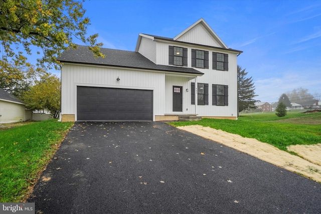 view of front facade featuring a front yard and a garage