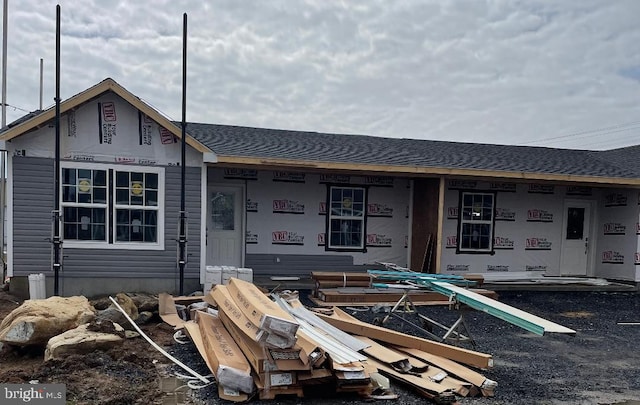 view of front of house featuring roof with shingles