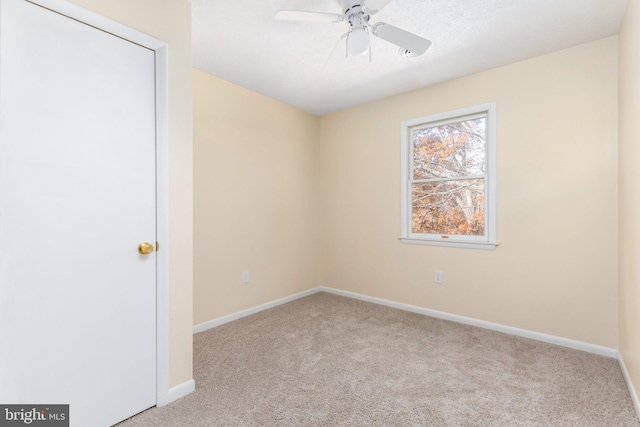 carpeted empty room with ceiling fan