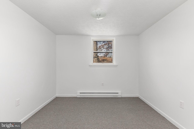 empty room featuring a baseboard radiator, a textured ceiling, and carpet