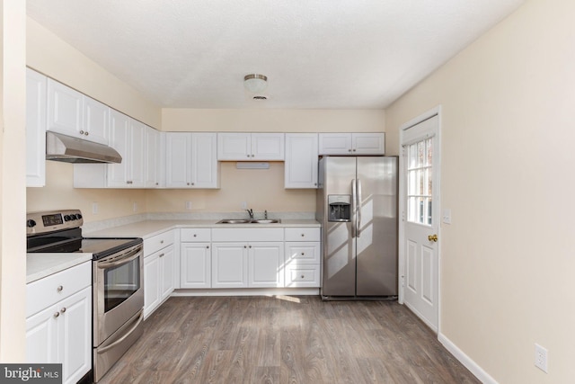 kitchen with white cabinets, hardwood / wood-style flooring, sink, and stainless steel appliances