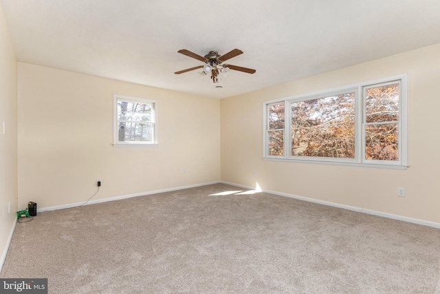 empty room featuring light carpet and ceiling fan