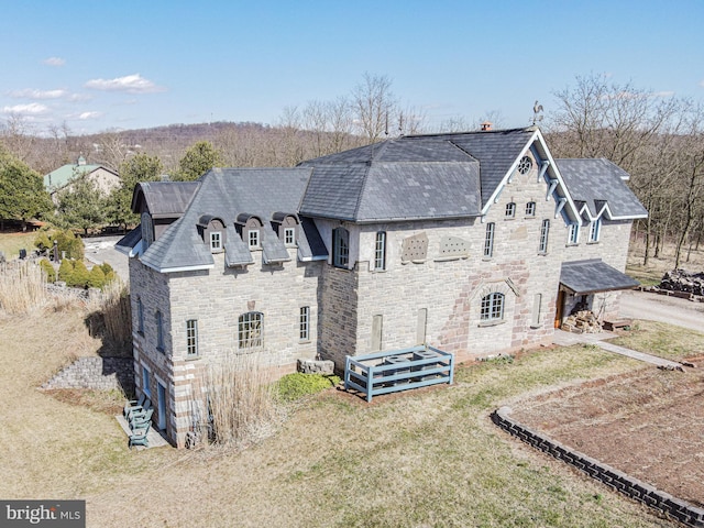 rear view of property featuring a yard