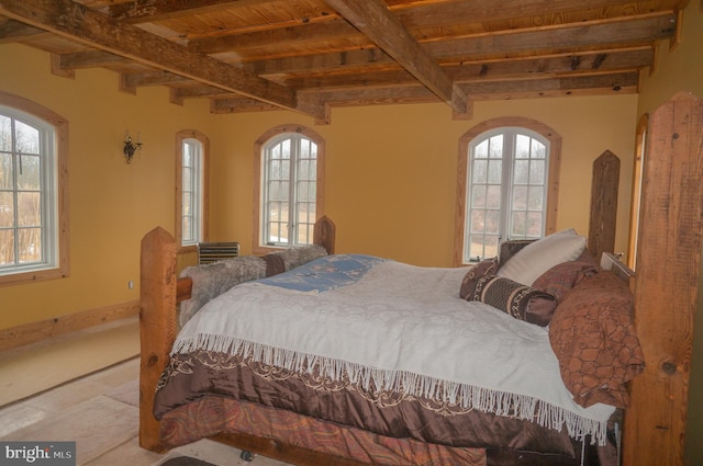 tiled bedroom featuring multiple windows, wood ceiling, and beam ceiling