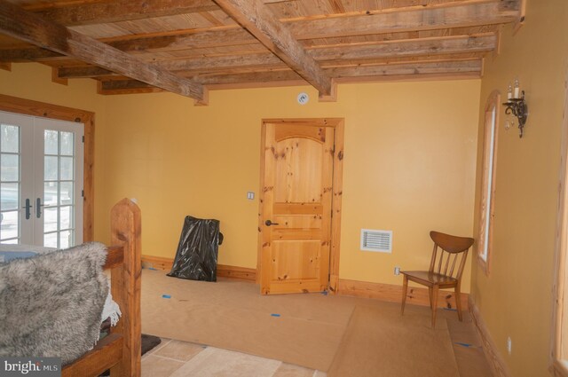 interior space with french doors, beam ceiling, wood ceiling, and light tile floors