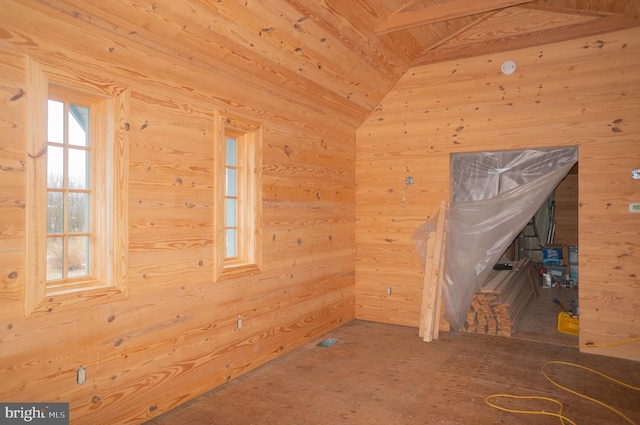 interior space featuring wooden walls and lofted ceiling