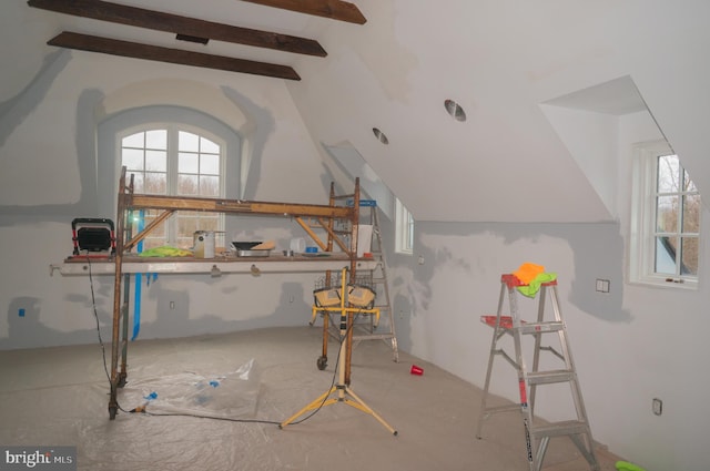 additional living space with vaulted ceiling with beams