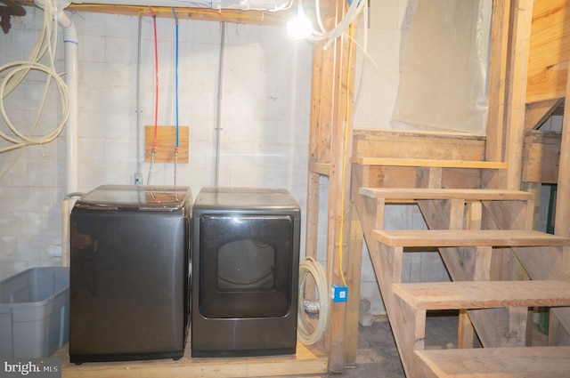 clothes washing area featuring washer and clothes dryer