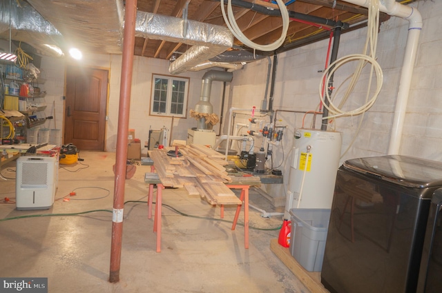 basement with water heater and washer / dryer