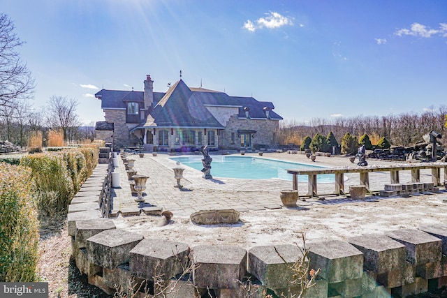 view of pool featuring a patio area