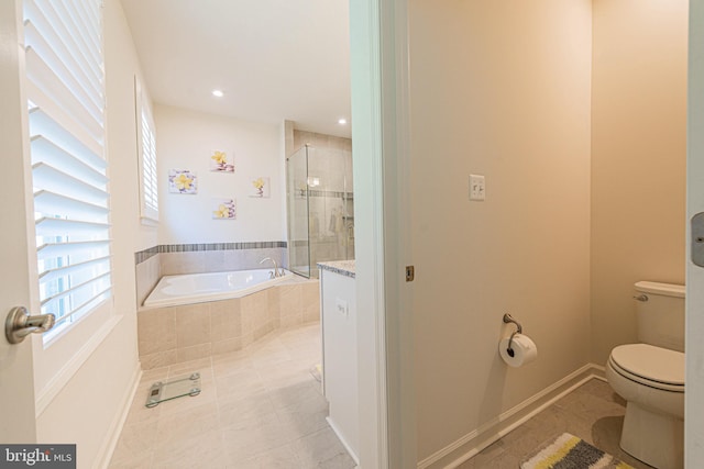 bathroom with tiled bath, tile flooring, and toilet