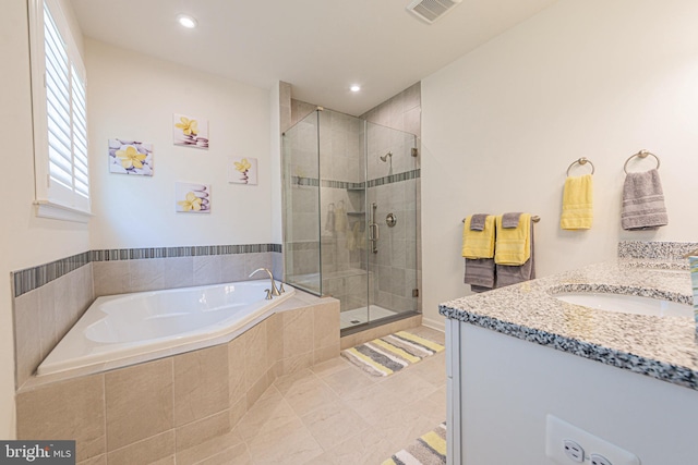 bathroom with tile flooring, separate shower and tub, and vanity