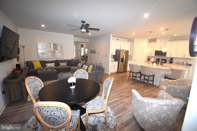 dining space featuring ceiling fan and hardwood / wood-style flooring