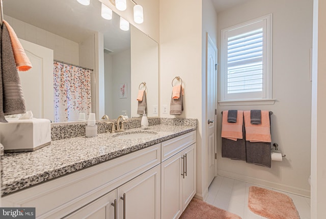 bathroom featuring tile floors and vanity with extensive cabinet space