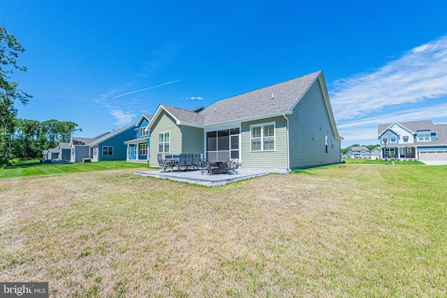 back of house featuring a yard and a patio area