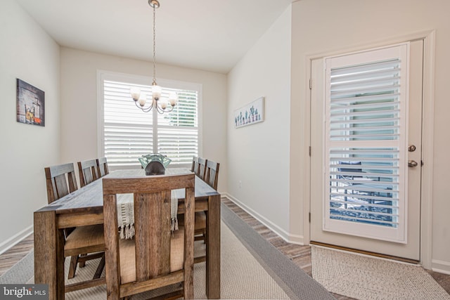 dining space featuring a chandelier and dark hardwood / wood-style flooring