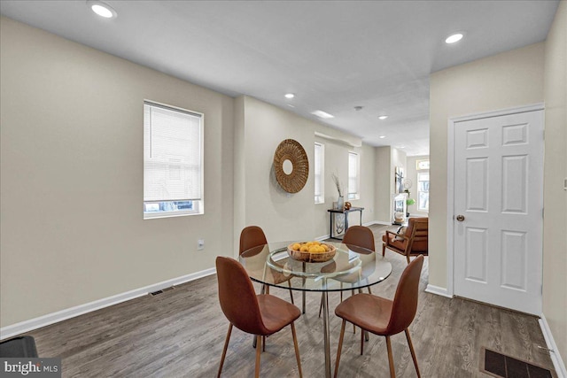 dining area featuring dark hardwood / wood-style flooring and plenty of natural light