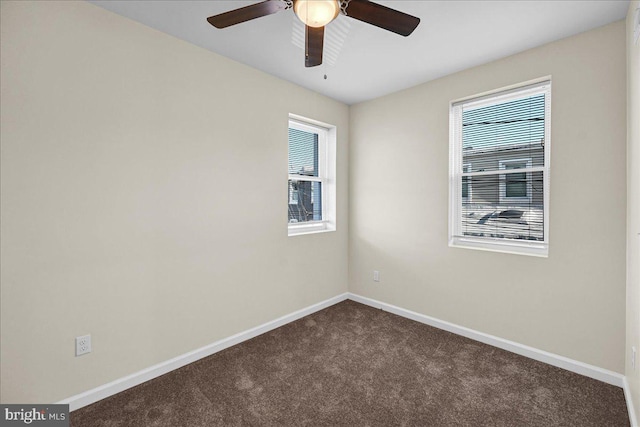 carpeted spare room with ceiling fan