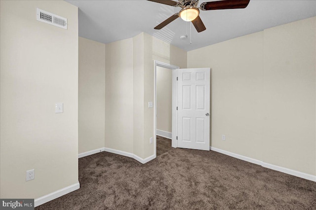 unfurnished bedroom with ceiling fan and dark carpet