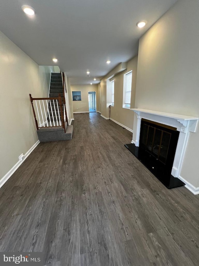 unfurnished living room featuring dark wood-type flooring