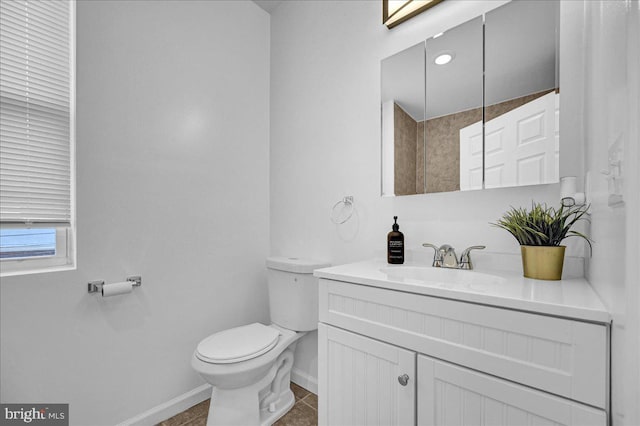 bathroom featuring vanity, tile floors, and toilet