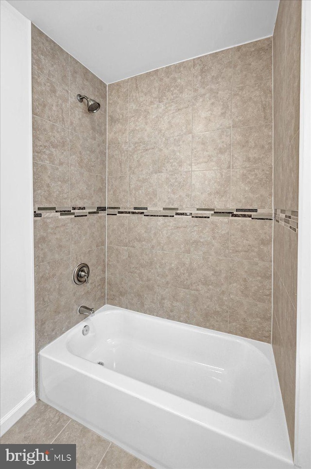 bathroom with tile floors and tiled shower / bath