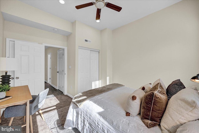 bedroom with ceiling fan, a closet, and dark colored carpet