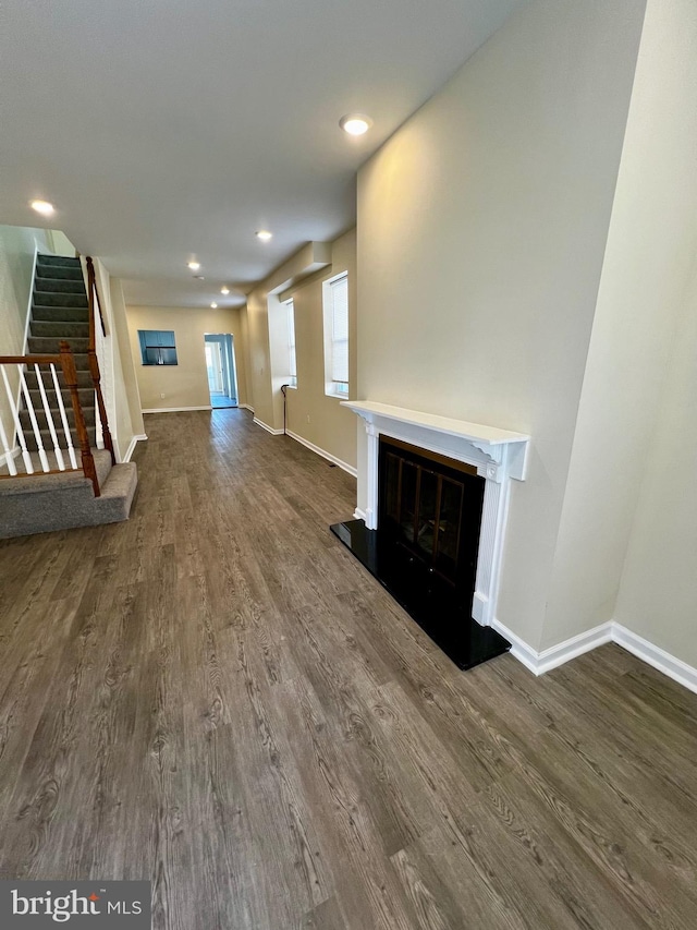 unfurnished living room featuring dark wood-type flooring