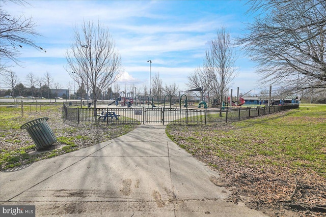 view of home's community with a lawn and a playground