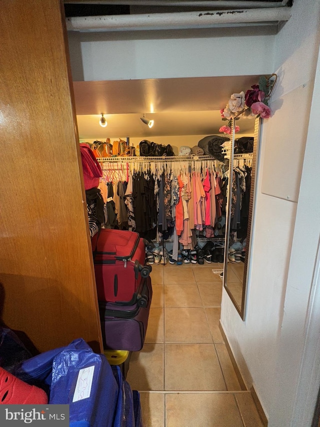 walk in closet featuring tile patterned flooring