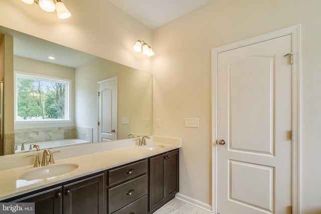 bathroom featuring double sink vanity, tile flooring, and a tub