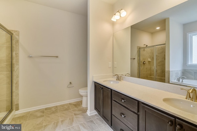 full bathroom featuring tile flooring, dual sinks, toilet, vanity with extensive cabinet space, and shower with separate bathtub