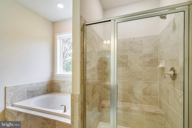 bathroom featuring separate shower and tub