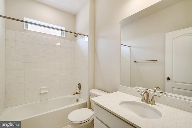 full bathroom featuring toilet, tiled shower / bath combo, and oversized vanity