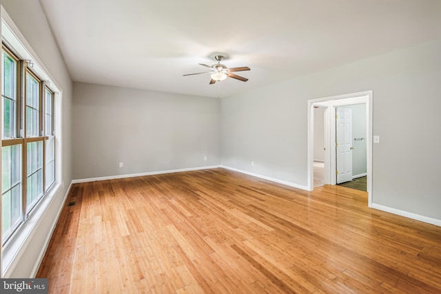 unfurnished room with ceiling fan and wood-type flooring