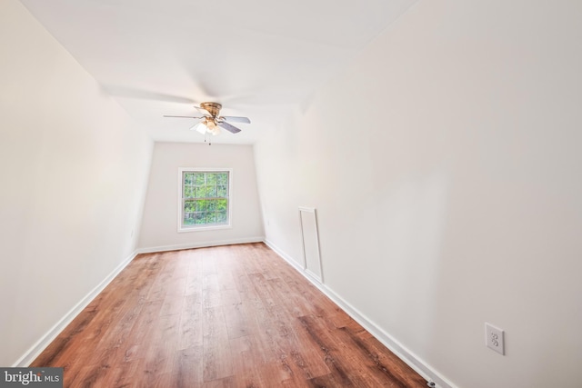 empty room with ceiling fan and wood-type flooring