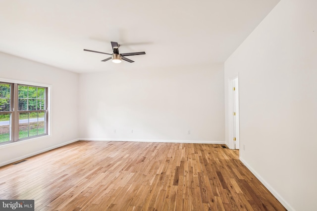 empty room featuring ceiling fan and light hardwood / wood-style flooring