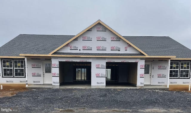 view of front of property with a shingled roof and crawl space