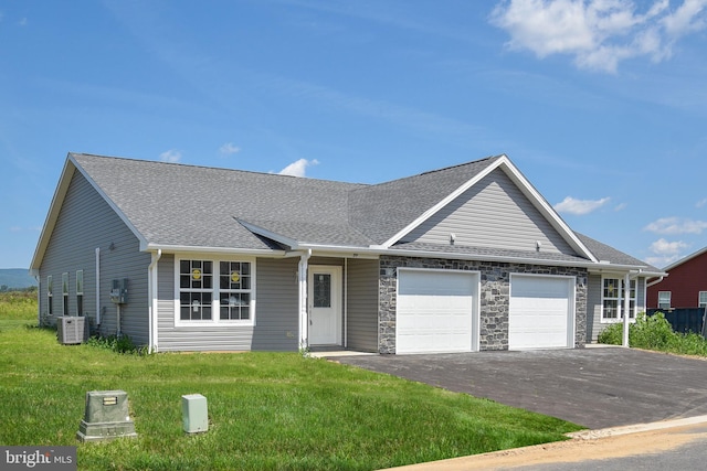 single story home featuring roof with shingles, central AC unit, a front yard, a garage, and stone siding