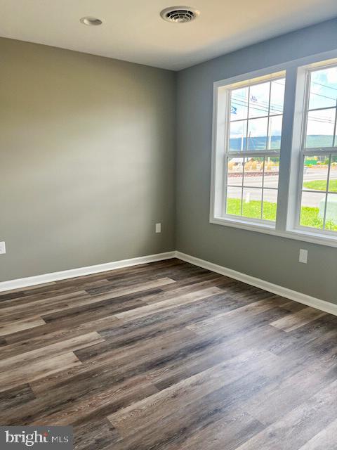 unfurnished room featuring dark hardwood / wood-style floors