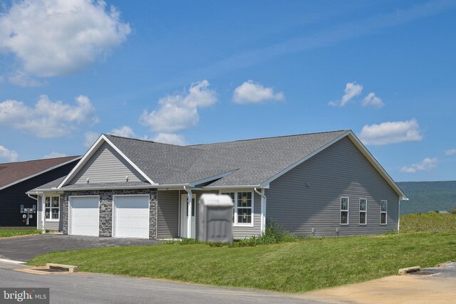 ranch-style house with a garage and a front yard