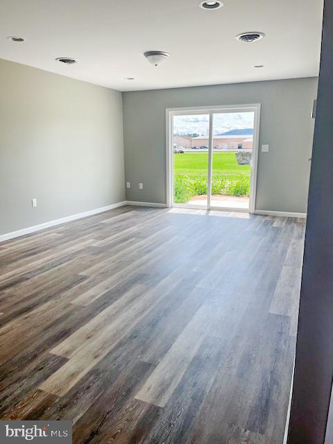 empty room with hardwood / wood-style floors