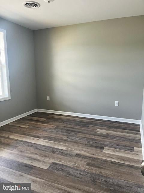 unfurnished room with dark hardwood / wood-style floors