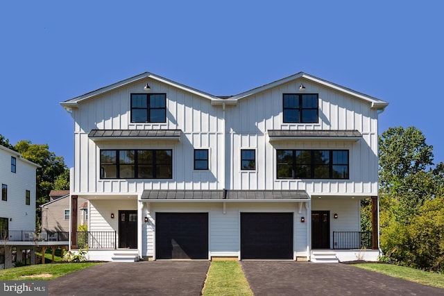 view of front facade with covered porch and a garage