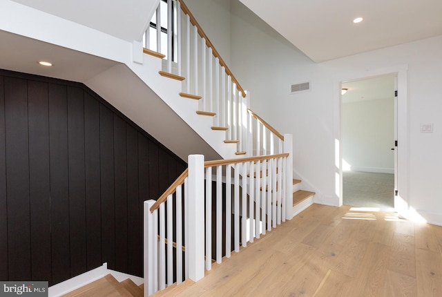 staircase with light hardwood / wood-style flooring