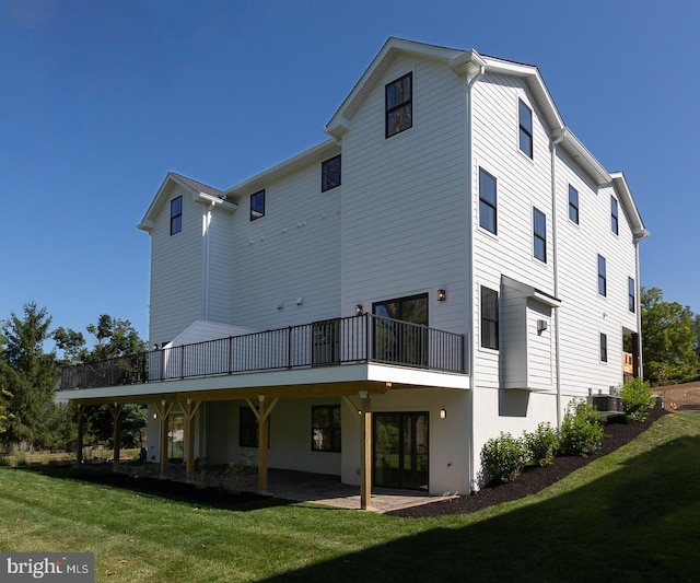 back of property with a lawn and central AC unit