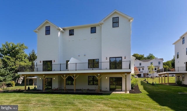 rear view of property featuring a lawn