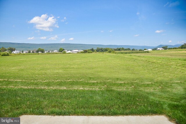 surrounding community featuring a yard, a water view, and a rural view