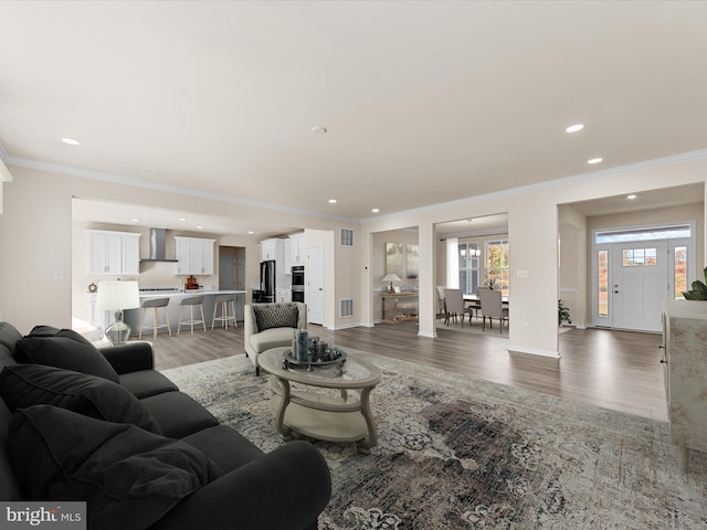 living room featuring hardwood / wood-style floors and ornamental molding