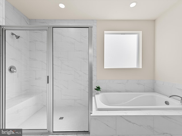 bathroom with shower with separate bathtub